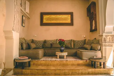 a living room with a couch and two tables at Riad Enchanté in Marrakech