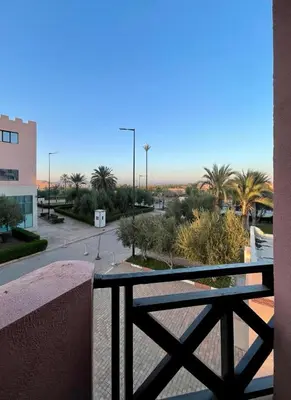 a balcony with a view of a parking lot at Calme et sérénité 5 piscines Palmeraie in Marrakech