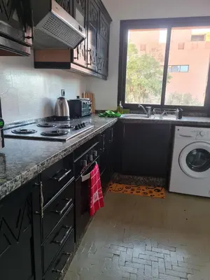 a kitchen with a sink and a washing machine at Calme et sérénité 5 piscines Palmeraie in Marrakech