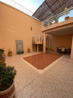 an empty courtyard with a balcony and a patio at Peaceful Retreat with pool in Marrakech