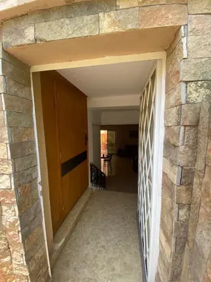 an open doorway into a room with a stone wall at Peaceful Retreat with pool in Marrakech