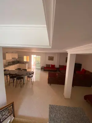 a large living room with a table and chairs at Peaceful Retreat with pool in Marrakech