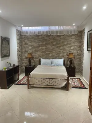 a bedroom with a large bed and two night stands at Peaceful Retreat with pool in Marrakech