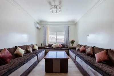 a living room with a large couch with pillows at Chic et climatisé au centre de gueliz in Marrakech