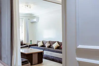 a living room with a couch and a table at Chic et climatisé au centre de gueliz in Marrakech