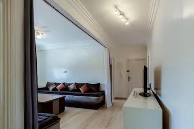 a living room with a couch and a mirror at Chic et climatisé au centre de gueliz in Marrakech