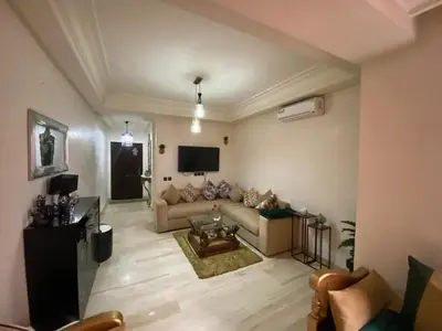 a living room with a couch and a tv at Agréable, cosy, proche du centre in Marrakech
