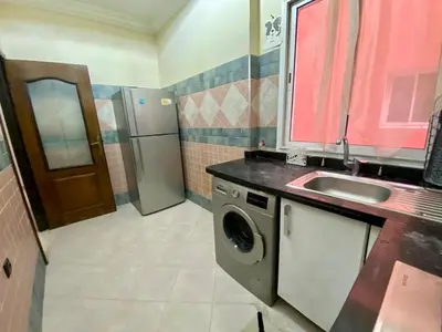 a kitchen with a sink and a washing machine at Agréable, cosy, proche du centre in Marrakech