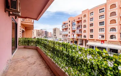 a balcony of a building with green plants at Appartement Jasmin in Marrakech