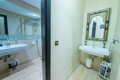 a bathroom with two sinks and a mirror at Appartement Jasmin in Marrakech
