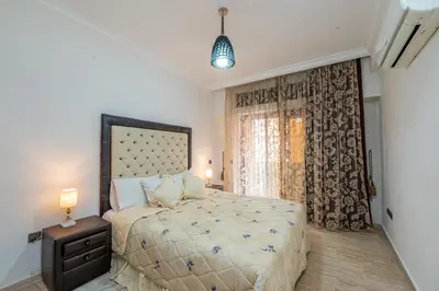 a bedroom with a large bed and a window at Appartement Jasmin in Marrakech