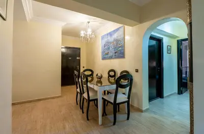 a dining room with a table and chairs at Appartement Jasmin in Marrakech
