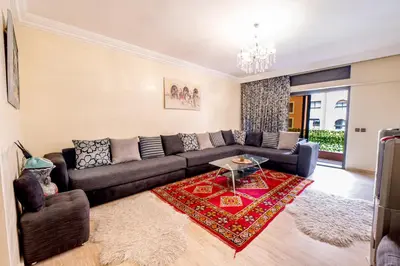 a living room with a couch and a table at Appartement Jasmin in Marrakech