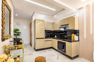 a large kitchen with black counter tops and appliances at Guéliz Centre-Appartement Chic près Carré Eden in Marrakech