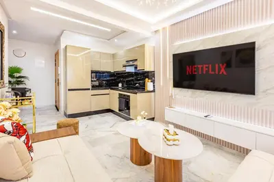 a living room with a television on a wall at Guéliz Centre-Appartement Chic près Carré Eden in Marrakech