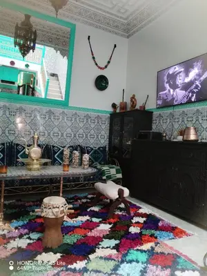a living room with a colorful rug on the floor at ATHIKA Hostel in Marrakech
