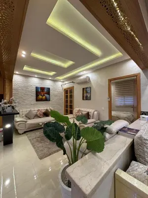 a living room with a couch and a plant at Comfort and charm 10 min from Guéliz in Marrakech