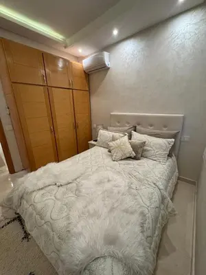 a bedroom with a large white bed with pillows at Comfort and charm 10 min from Guéliz in Marrakech