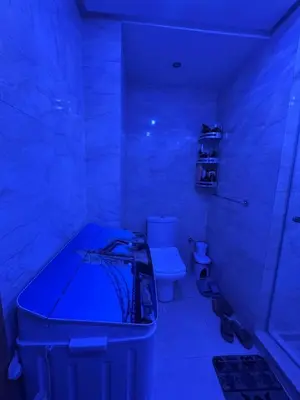 a bathroom with a toilet and a blue light at Comfort and charm 10 min from Guéliz in Marrakech