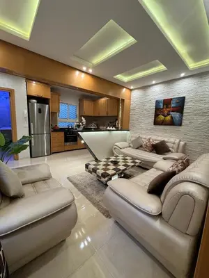 a living room with two couches and a kitchen at Comfort and charm 10 min from Guéliz in Marrakech