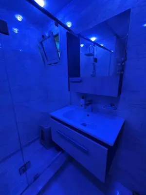 a bathroom with a white sink and a mirror at Comfort and charm 10 min from Guéliz in Marrakech