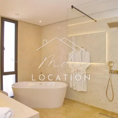 a bathroom with a tub and a sign that reads modern coalition at Villa Dar M in Marrakech