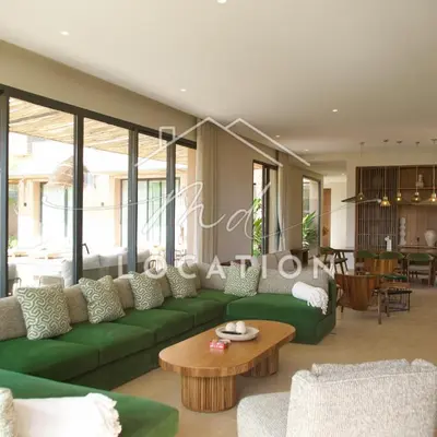 a living room with a green couch and a table at Villa Dar M in Marrakech