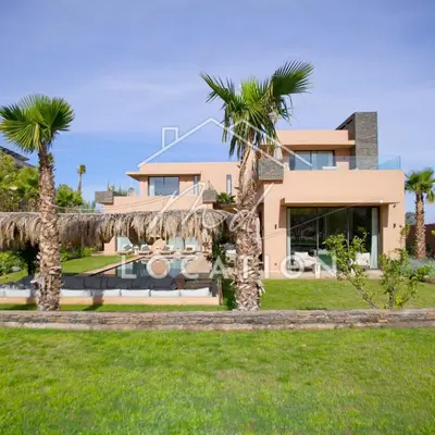 a house with palm trees in front of it at Villa Dar M in Marrakech