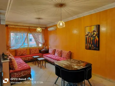 a living room with a red couch and a table at le Marrakchi in Marrakech