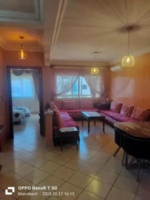 a living room with a red couch and a table at le Marrakchi in Marrakech