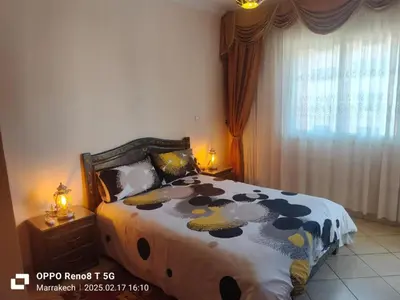 a bedroom with a bed with a cow patterned blanket at le Marrakchi in Marrakech