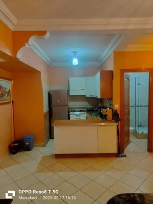 a kitchen with orange walls and a counter top at le Marrakchi in Marrakech