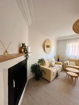a living room with a couch and a fireplace at The Pearl of Guelliz in Marrakech