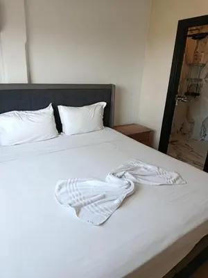 a white blanket laying on top of a bed at Kamal Atoumi in Marrakech