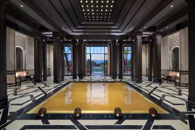 a lobby with a pool in the middle of a building at Mandarin Oriental, Marrakech in Marrakech