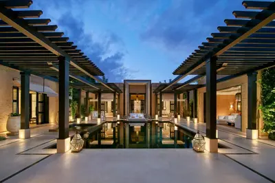 an exterior view of a villa with a swimming pool at Mandarin Oriental, Marrakech in Marrakech