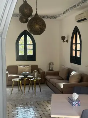 a living room with a couch and a table at Cosy villa a marrakech in Marrakech
