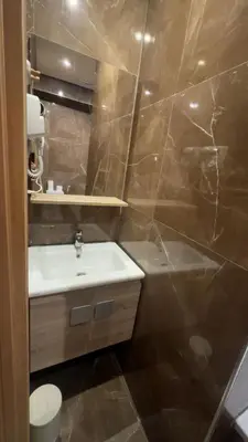 a bathroom with a sink and a bath tub at Oas i Medina & fantastisk terrass in Marrakech