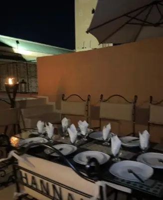 a table with plates and napkins on top at Oas i Medina & fantastisk terrass in Marrakech