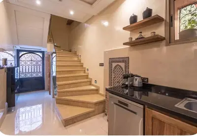 a kitchen with a staircase and a stair case at Oas i Medina & fantastisk terrass in Marrakech
