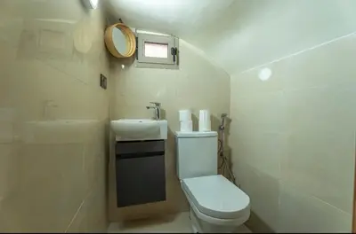 a small bathroom with a toilet and a sink at Oas i Medina & fantastisk terrass in Marrakech