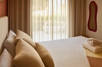 a bedroom with a bed with pillows and a window at Mounir Hamari in Marrakech