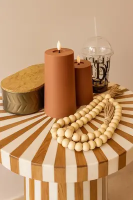 a table with two candles and a bowl and a candle holder at Mounir Hamari in Marrakech