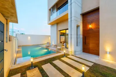 a swimming pool in the backyard of a house at Villa moderne à 5 mins du centre-ville de Marrakech in Marrakech