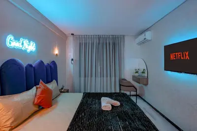 a hotel room with a bed and a tv at Modern Flat Gueliz Near Medina Netflix AC in Marrakech