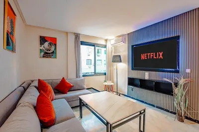 a living room with a couch and a tv at Modern Flat Gueliz Near Medina Netflix AC in Marrakech