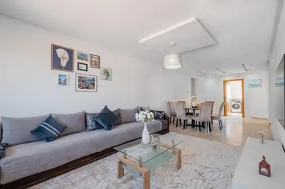 a living room with a couch and a table at 2BR Retreat in Hivernage Center with Pool, Balcony & Parking in Marrakech