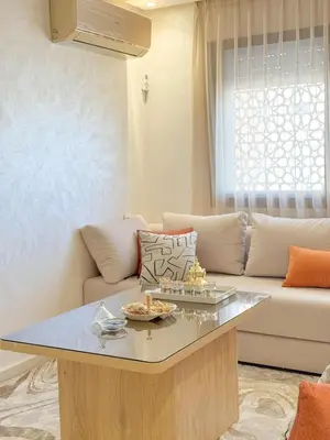 a living room with a couch and a table at La perle de Marrakech in Marrakech
