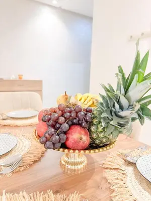 a table with a bowl of fruit on a table at La perle de Marrakech in Marrakech
