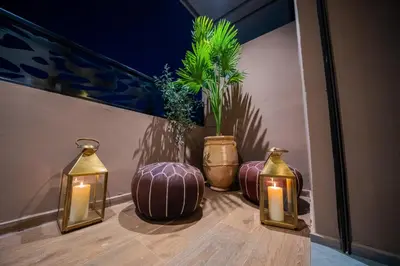 a group of three vases with candles and lights at Modern Moroccan Apartment in Gueliz with Terrace in Marrakech